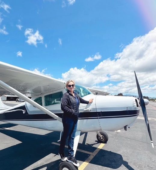 Pilot standing with the Cessna 170 on the ramp